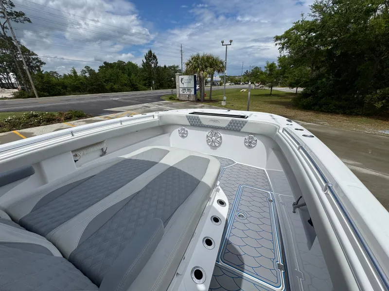 Slide: The Image of 2022 Invincible 33 Catamaran with spacious seating and modern design, docked outdoors. - 22