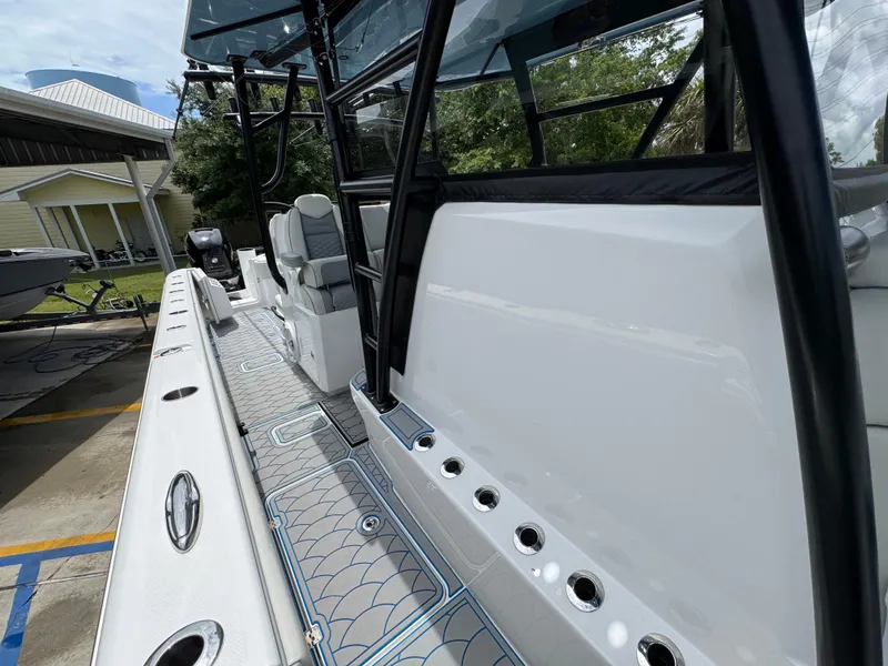 Slide: The Image of 2022 Invincible 33 Catamaran, sleek design, spacious deck, modern features, docked outdoors. - 26
