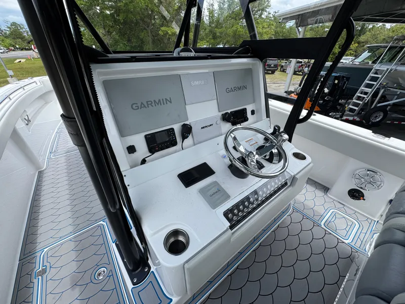 Slide: The Image of 2022 Invincible 33 Catamaran helm with Garmin displays and modern controls. - 32