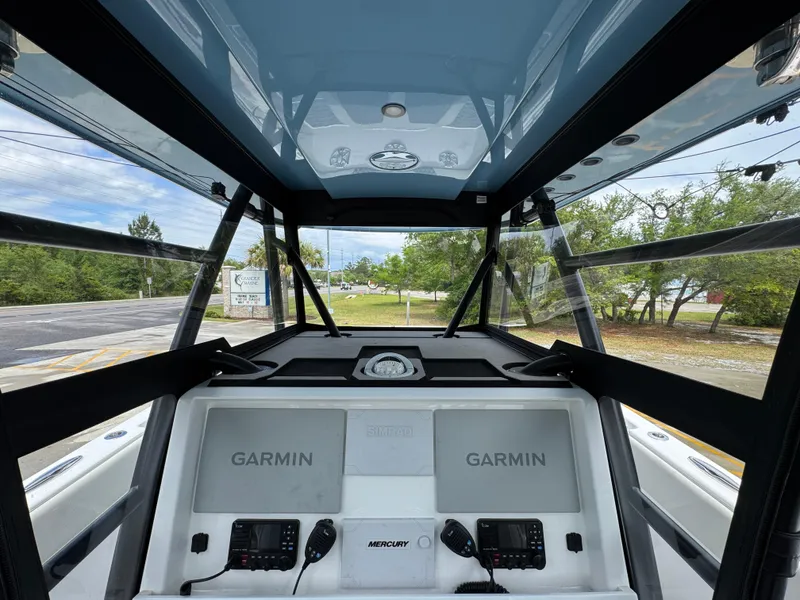 Slide: The Image of 2022 Invincible 33 Catamaran cockpit with dual Garmin displays and Mercury controls. - 34