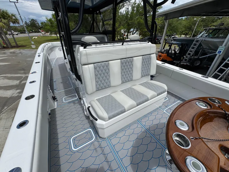 Slide: The Image of 2022 Invincible 33 Catamaran interior with cushioned seating and stylish deck design. - 35