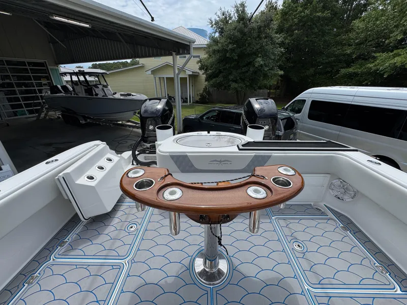 Slide: The Image of 2022 Invincible 33 Catamaran with fishing setup, docked in a garage. - 39