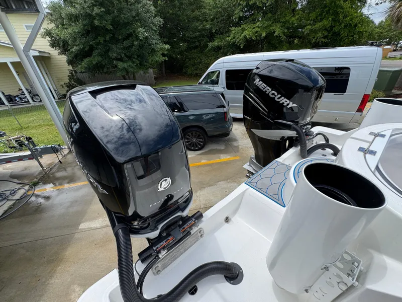 Slide: The Image of 2022 Invincible 33 Catamaran with dual Mercury outboard engines in a driveway setting. - 43