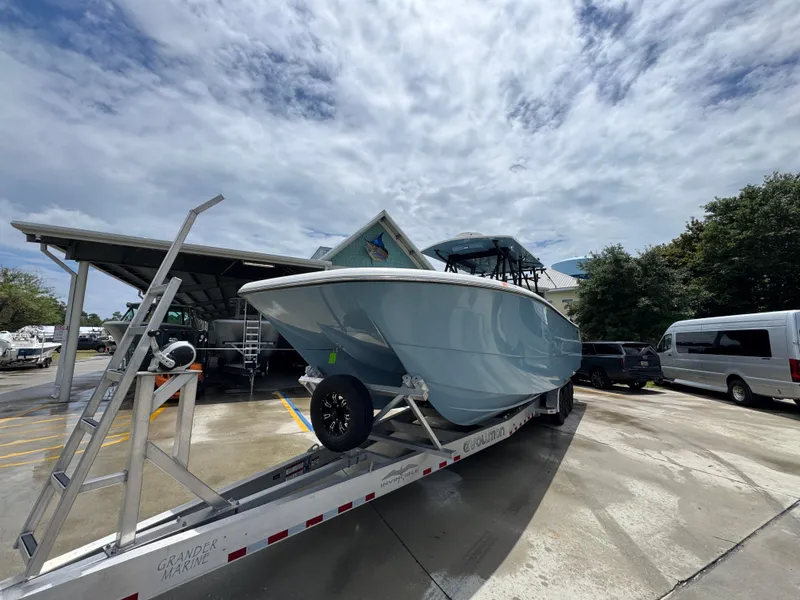 Slide: The Image of 2022 Invincible 33 Catamaran on trailer under cloudy sky at marina. - 5