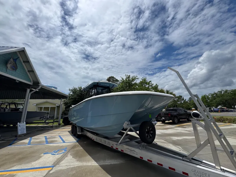 Slide: The Image of 2022 Invincible 33 Catamaran on trailer under cloudy sky at marina. - 8