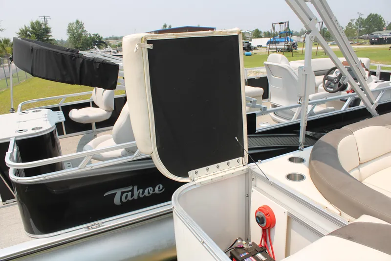 Slide: The Image of 2021 Tahoe LTZ Cruise pontoon boat with seating and open storage compartment. - 8