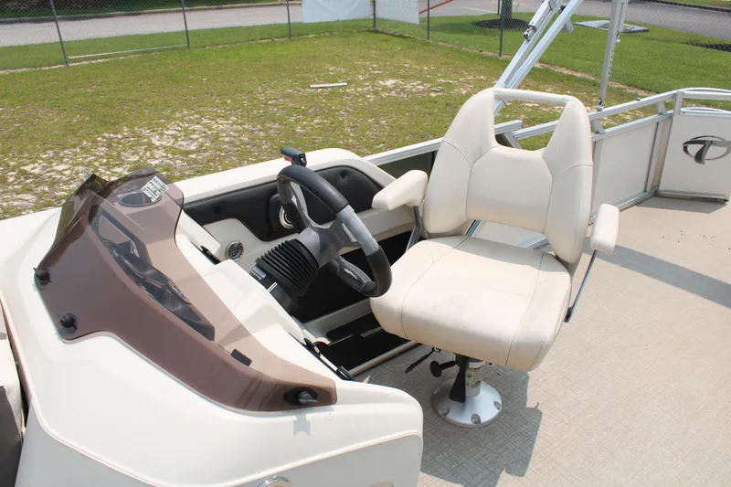 Slide: The Image of 2021 Tahoe LTZ Cruise boat helm with beige captain's chair and steering wheel. - 9