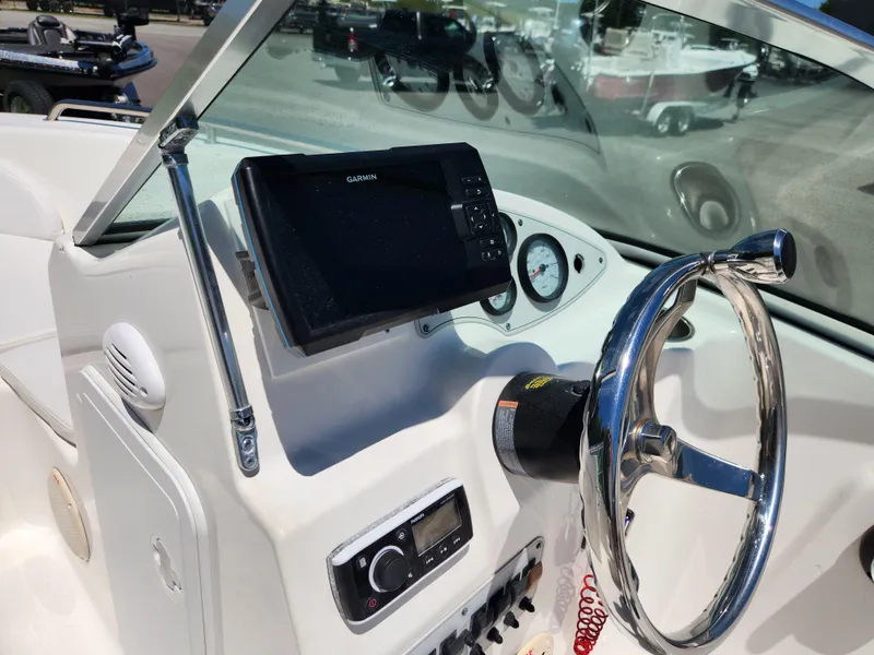 Slide: The Image of 2014 Tidewater 196 DC boat dashboard with steering wheel and navigation system. - 12