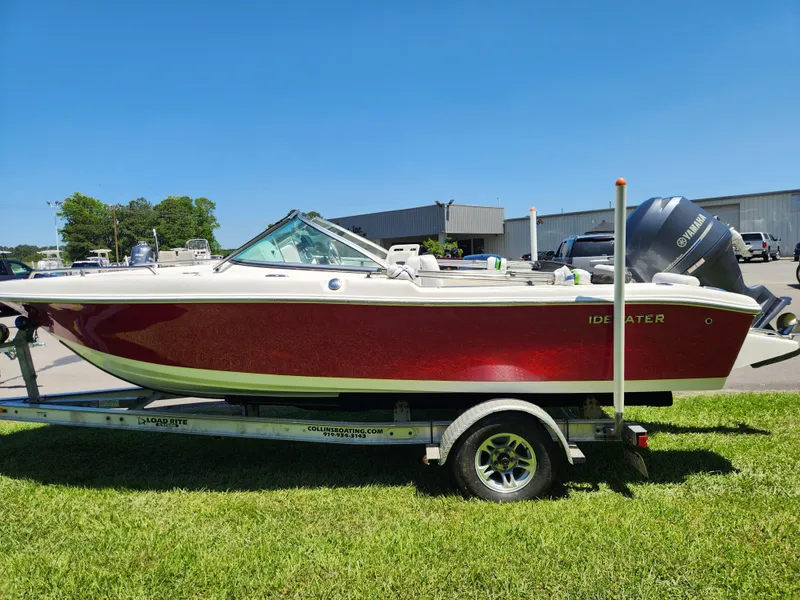 Slide: The Image of 2014 Tidewater 196 DC boat on trailer, red hull, parked on grass. - 5