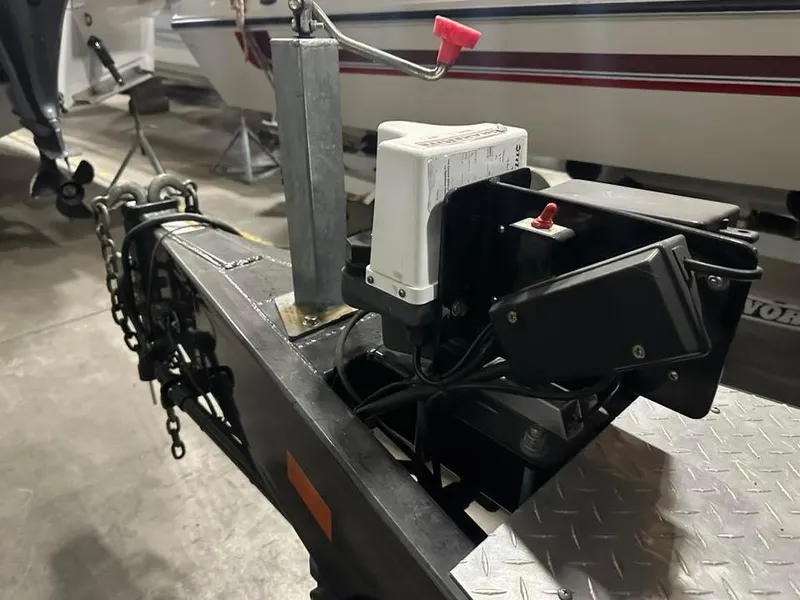 Slide: The Image of Trailer hitch with chains and brake system, MTI 340X, 2018 model, in a garage setting. - 17