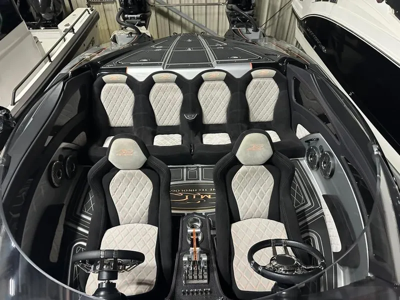 Slide: The Image of Luxurious interior of a 2018 MTI 340X boat with quilted seats and dual steering wheels. - 6