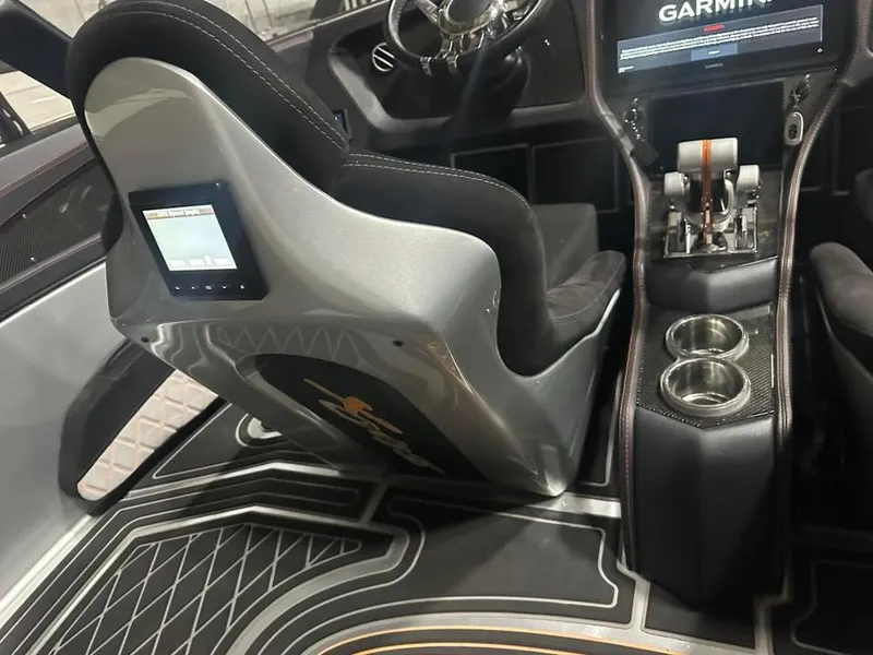 Slide: The Image of Interior of 2018 MTI 340X boat with Garmin display and sleek seating. - 7