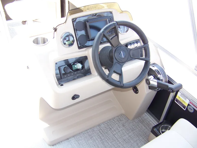 Slide: The Image of Steering console of 2025 Avalon VTX Quad Fish boat with modern controls and dashboard. - 9