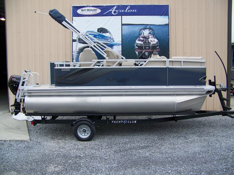 The Image of 2025 Avalon Venture Rear Fish pontoon boat on trailer, displayed outdoors. - 1