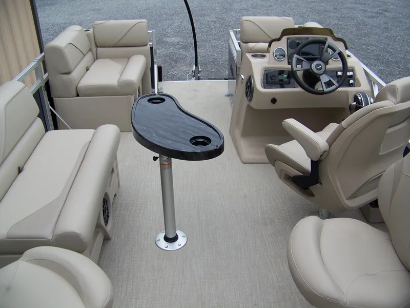 Slide: The Image of 2025 Avalon Venture Rear Fish boat interior with beige seating and modern steering console. - 12