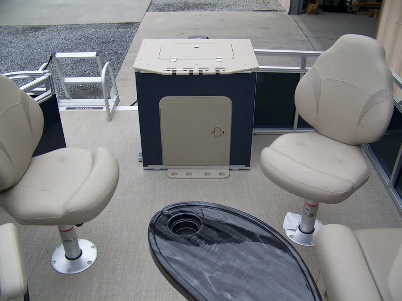 Slide: The Image of 2025 Avalon Venture Rear Fish boat interior with beige seating and a small table. - 7