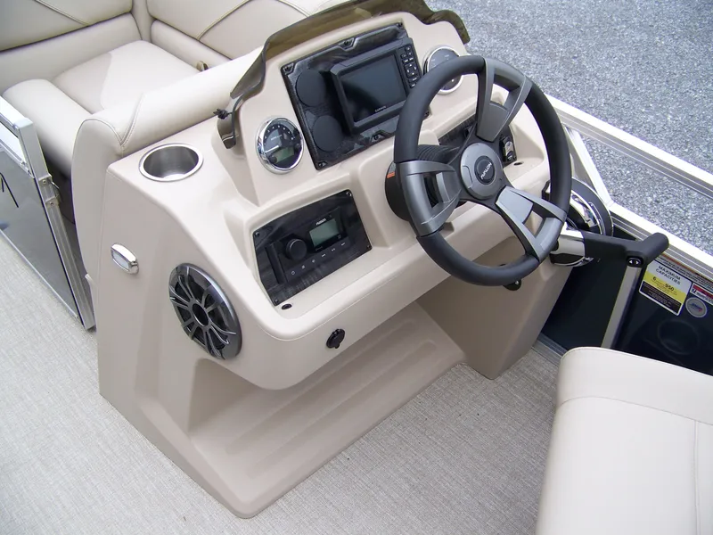 Slide: The Image of 2025 Avalon Venture Rear Fish boat dashboard with steering wheel and control panel. - 8