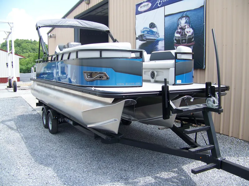 Slide: The Image of 2025 Avalon VENTURE 85 CRUISE pontoon boat on trailer, parked outdoors. - 3