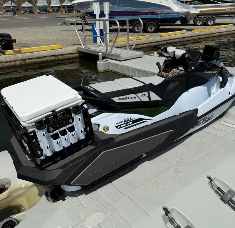 Slide: The Image of 2025 Kawasaki Ultra 160LX-S Angler jet ski docked at marina. - 4