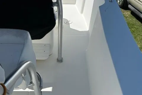 Slide: The Image of 2003 Aquasport 250 Osprey boat interior with seating and railing. - 10
