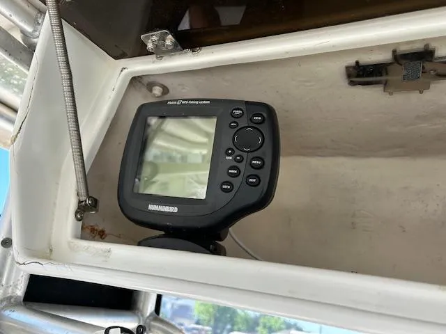 Slide: The Image of Fishfinder device installed on a 2003 Aquasport 250 Osprey boat dashboard. - 12
