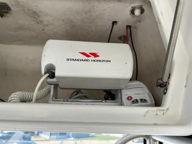 Slide: The Image of Standard Horizon radio equipment inside a 2003 Aquasport 250 Osprey boat compartment. - 13