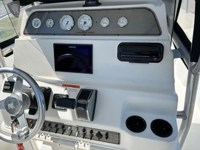 Slide: The Image of Console of 2003 Aquasport 250 Osprey boat with gauges and controls. - 14