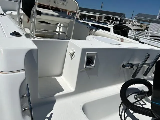 Slide: The Image of 2003 Aquasport 250 Osprey boat interior, featuring seating and deck details. - 5