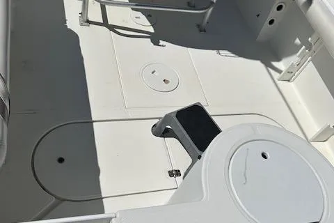 Slide: The Image of 2003 Aquasport 250 Osprey boat interior, featuring clean white deck and seating area. - 7