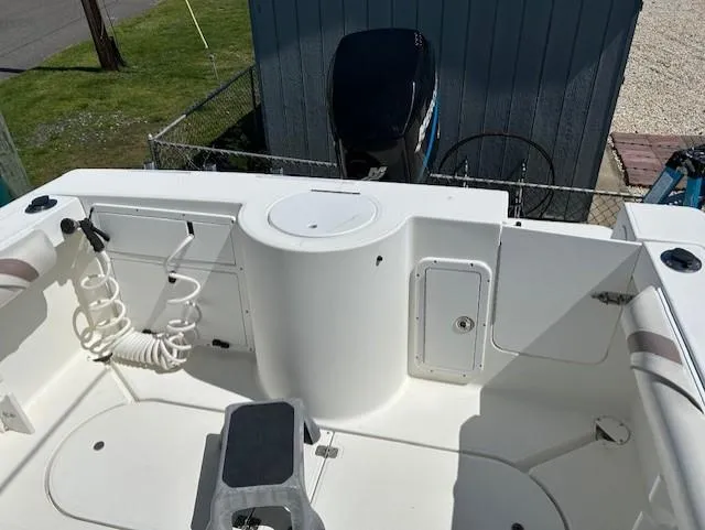 Slide: The Image of 2003 Aquasport 250 Osprey boat deck with storage compartments and coiled hose. - 8