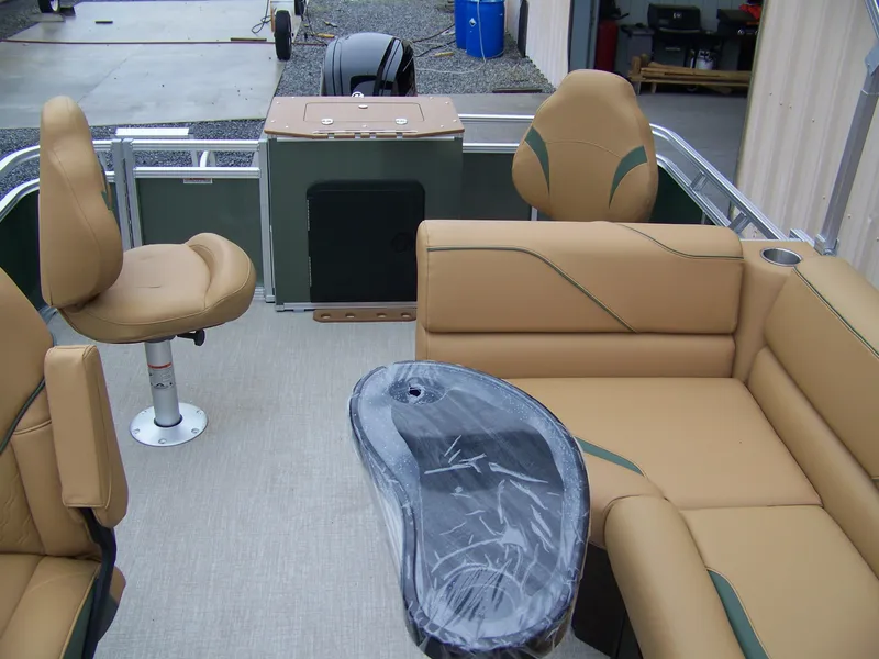 Slide: The Image of 2025 Avalon Venture Rear Fish pontoon boat interior with tan seating and modern design. - 12