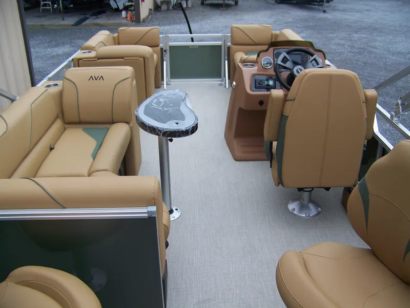 Slide: The Image of 2025 Avalon Venture Rear Fish pontoon boat interior with tan seating and modern dashboard. - 14