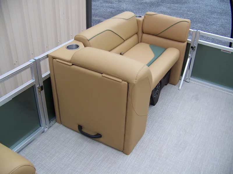 Slide: The Image of 2025 Avalon Venture Rear Fish boat interior with tan seating and cup holder. - 15
