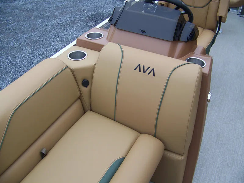 Slide: The Image of 2025 Avalon Venture Rear Fish boat interior with tan seating and cup holders. - 6