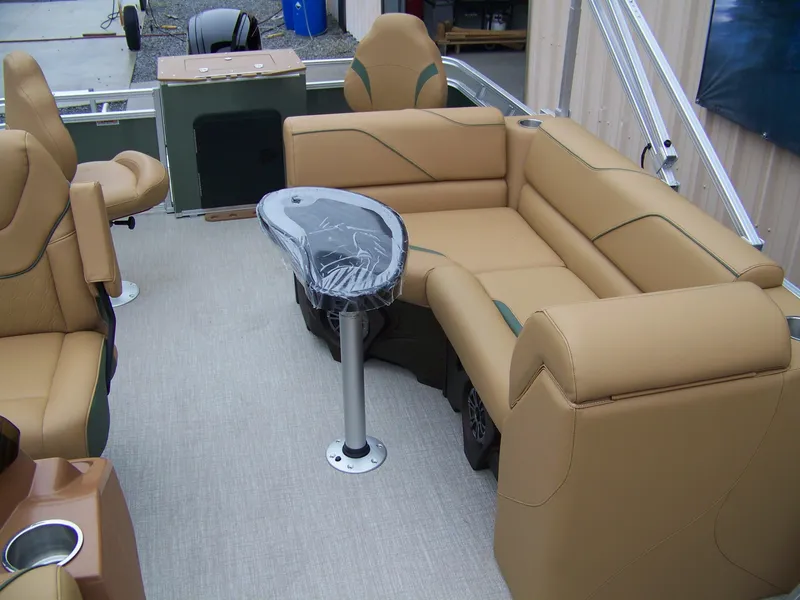 Slide: The Image of 2025 Avalon Venture Rear Fish boat interior with tan seating and a central table. - 8