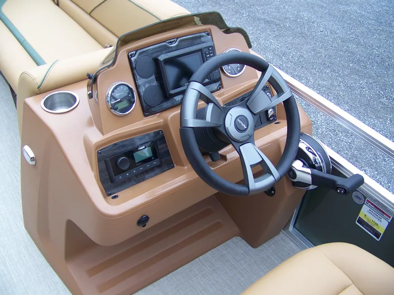 Slide: The Image of 2025 Avalon Venture Rear Fish boat dashboard with steering wheel and controls. - 9