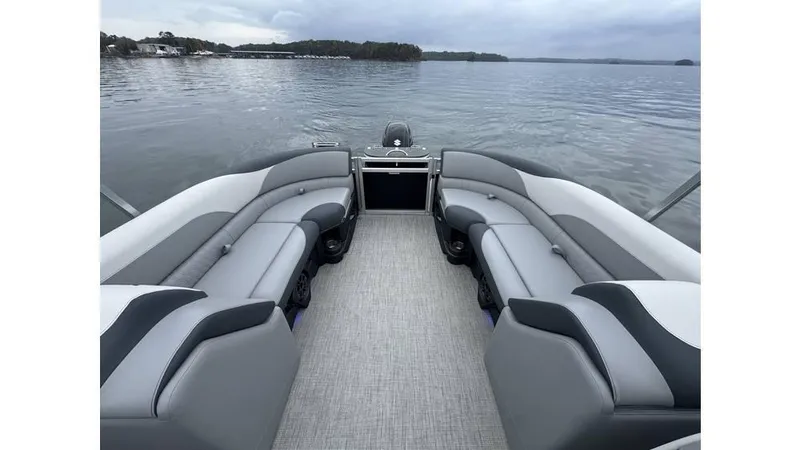 Slide: The Image of 2025 Tahoe Pontoon LTZ Quad Lounger on serene lake, showcasing spacious seating and elegant design. - 4