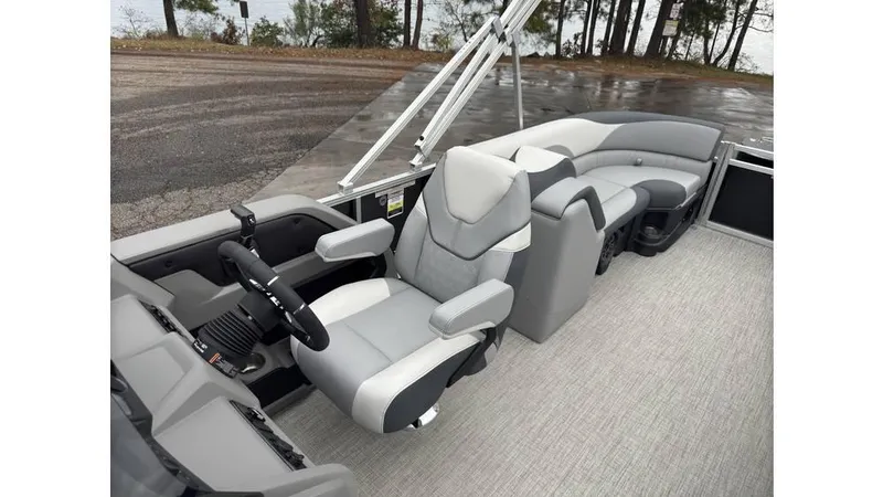 Slide: The Image of 2025 Tahoe Pontoon LTZ Quad Lounger interior with modern seating and steering wheel. - 7