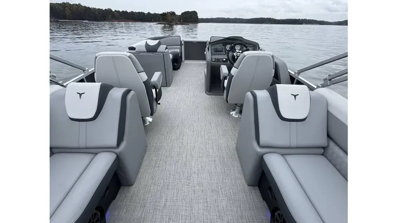 Slide: The Image of 2025 Tahoe Pontoon LTZ Quad Lounger on a serene lake, featuring luxurious seating and modern design. - 9