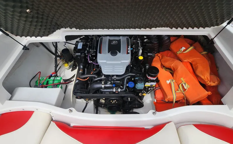 Slide: The Image of 2013 Tahoe Q5i boat engine compartment with life jackets and battery. - 10