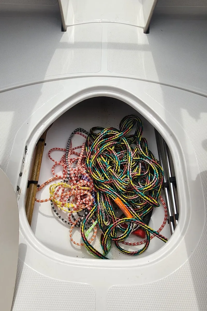 Slide: The Image of Storage compartment in a 2013 Tahoe Q5i boat with colorful ropes inside. - 11
