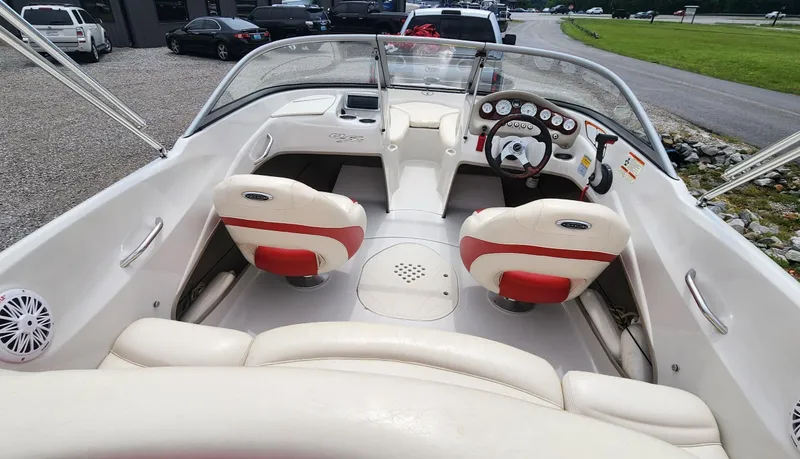 Slide: The Image of 2013 Tahoe Q5i boat interior with white and red seating, dashboard, and steering wheel. - 6