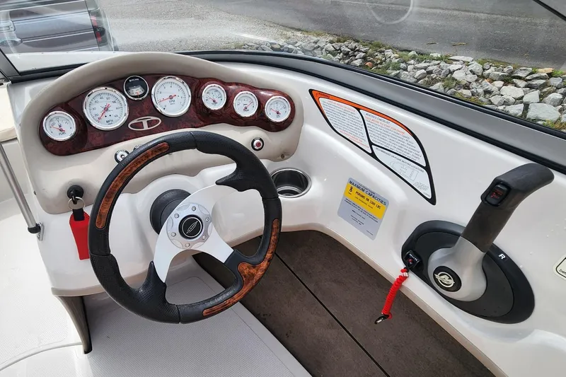 Slide: The Image of Steering console of a 2013 Tahoe Q5i boat with gauges and controls. - 9