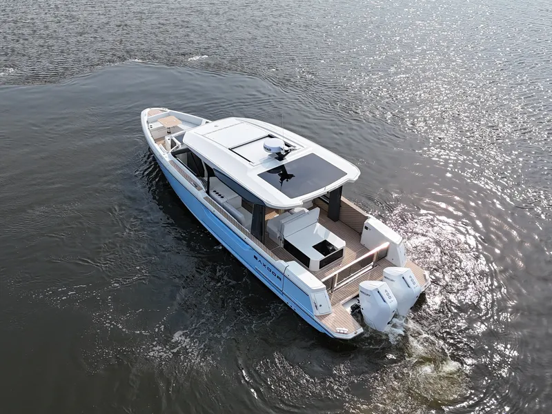 Slide: The Image of A 2026 Saxdor 400 GTO cruising on calm water. It features a modern design and twin outboard engines. - 1