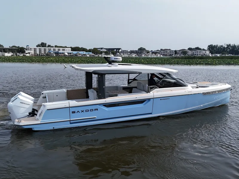 Slide: The Image of The image shows a Saxdor 400 GTO boat on calm waters. - 4