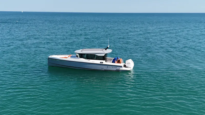 Slide: The Image of 2026 Saxdor 320 GTC on calm sea, featuring modern design and spacious deck. - 1
