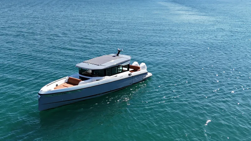 Slide: The Image of A 2026 Saxdor 320 GTC cruising on calm, blue waters. The boat features a modern design. - 2