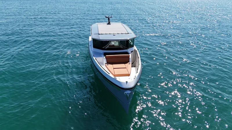Slide: The Image of Saxdor 320 GTC 2026 on calm water with modern design and spacious deck. - 8