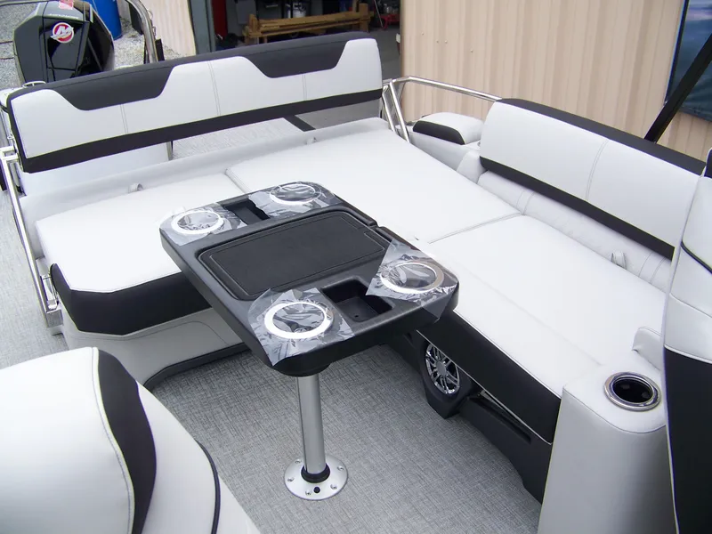 Slide: The Image of 2025 Avalon Catalina Cruise boat interior with rear bench and table setup. - 10