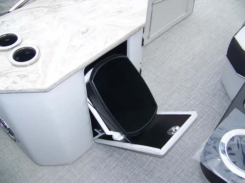 Slide: The Image of 2025 Avalon Catalina Cruise boat interior with hidden storage compartment and cup holders. - 12